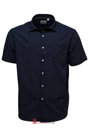 The Back Bay Bamboo Soft Touch Print Short Sleeve Shirt combines style and functionality, crafted from a polyester-cotton blend. It showcases a small geometric pattern in dark blue, paired with a classic collar and white buttons running down the front, all set on a plain white background.