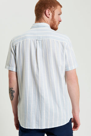 A man with a tattoo on his arm wears a crisp Ben Sherman Framed Candy Stripe Short Sleeve Shirt.