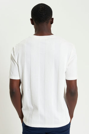 A man with short hair, facing away from the camera, wears a Ben Sherman Textured Vertical Stripe Tee in white and dark pants, set against a plain light background.