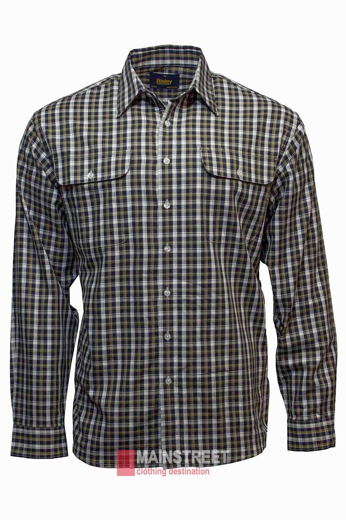 A long-sleeve, button-up Bisley Countryman Cotton Shirt with a checkered pattern in shades of black, white, and green. The shirt, made from 100% cotton, features two front pockets with flaps. A red Manstreet logo with the tagline "clothing destination" is visible at the bottom of the image.