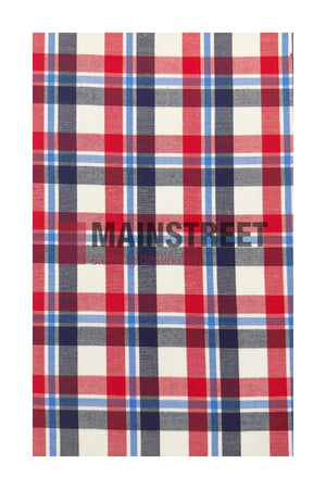 Red, white, and blue plaid fabric with horizontal and vertical stripes forming squares. "MAIN STREET" is faintly visible across the center, reminiscent of a Bisley Countryman Cotton Shirt with buttoned chest pockets.