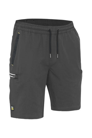 The Bisley Flex & Move 4 Way Stretch Elastic Waist Cargo Short comes in dark grey and features a drawstring waistband with side pockets. Made from durable Cordura® 4-way stretch fabric, these shorts also include a small reflective strip on the left pocket. A subtle logo is located near the hemline, seamlessly blending style and functionality for any activity.