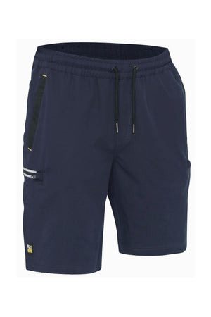 The Bisley Flex & Move 4 Way Stretch Elastic Waist Cargo Short in navy blue provides comfort and flexibility. Designed for active endeavors, these shorts feature 4-way stretch fabric, an elastic waistband with drawstrings, a zippered side pocket adorned with a subtle referee design, and a small logo on the lower left side.