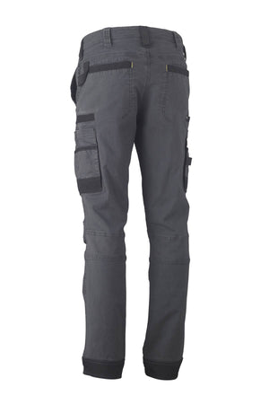 The image showcases the Bisley Flex & Move Stretch Utility Cargo Pant in dark gray, photographed from the back. Crafted from Cordura, these pants feature multiple cargo pockets, including large side pockets, and boast a rugged, durable design.