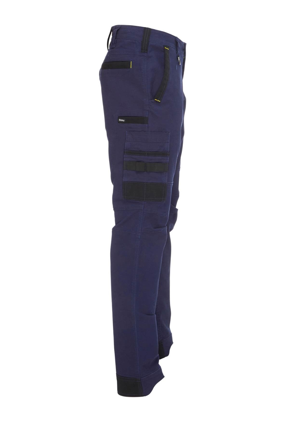 Side view of the Bisley Flex & Move Stretch Utility Cargo Pant in dark blue, featuring multiple cargo pockets on the side. The pants are designed with black accents and a fitted silhouette, enhanced by Cordura highlights for added durability, making them ideal for outdoor or work use.