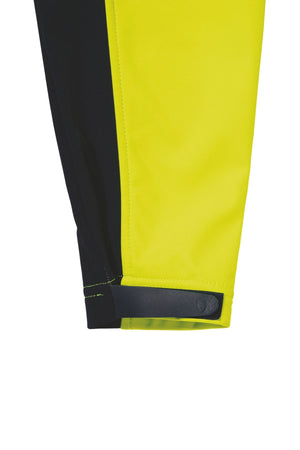 A close-up of the Bisley Hi Vis Soft Shell Taped Jacket reveals bright yellow and black fabric. There's a visible black adjustable strap with stitching detail on the right side, near the edge. This comfortable jacket is designed with reflective taping and boasts a sleek, modern aesthetic.