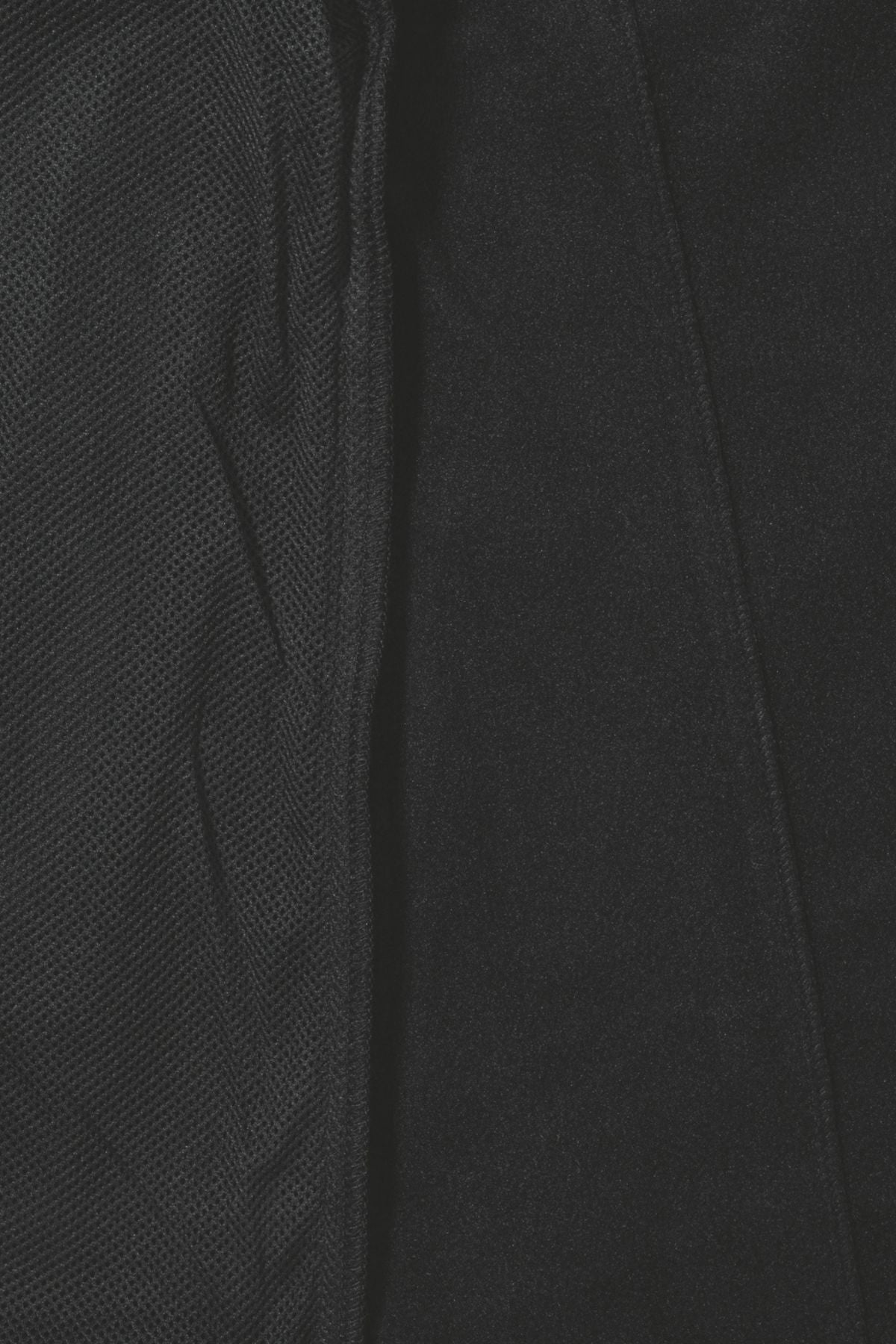 Close-up of the Bisley Soft Shell Jacket, showcasing a black textured fabric with contrasting surface texturesāa mesh pattern on the left and smoother material on the rightāreminiscent of its showerproof design, enhanced by reflective piping.