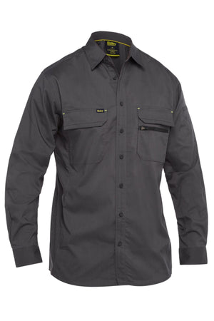 The Bisley X Airflow Stretch Ripstop Shirt is a long-sleeved, dark gray work shirt with two chest pockets (one zippered) and subtle yellow stitching accents. Lightweight and shown on a white background.