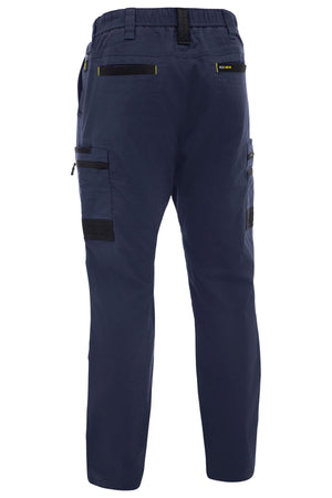 Bisley Flex & Move Stretch Canvas Elastic Waist Cargo Pant in navy blue, seen from the back, features stretch cotton canvas, multiple black zipper pockets, relaxed fit, elastic waistband, and bold black accents.