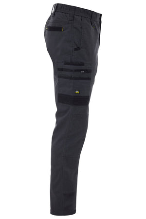 Side view of Bisley Flex & Move Stretch Canvas Elastic Waist Cargo Pant in dark gray, made from stretch cotton canvas with multiple zippered and flap pockets, reinforced Cordura® knee areas, and yellow stitching accents.