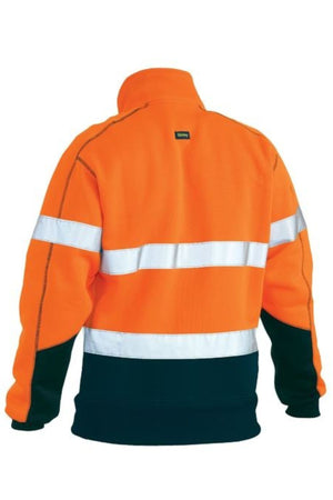 The Bisley Taped Hi Vis Fleece Pullover With Sherpa Lining is a bright orange, durable polyester fleece with wide silver reflective tape on the chest and arms, plus black lower sleeves and bottom, shown from the back.
