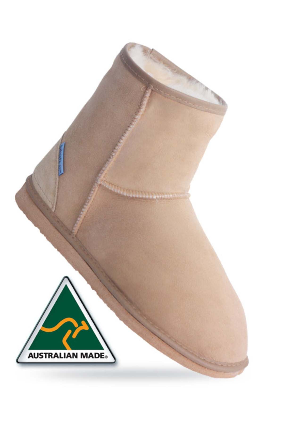 The Blue Sheep Ankle Uggies, tan sheepskin boots with soft lining, are angled to showcase their comfort and style. Featuring the Australian Made logo—a kangaroo inside a green triangle—these cozy boots are crafted from authentic Australian sheepskin.