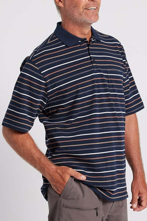 A person wearing a navy blue and white striped Breakaway Dariyan Cotton Pique Polo with short sleeves and a collar, paired with gray pants. The modern thin stripe design complements their beard as they stand against a plain background with one hand in their pant pocket.