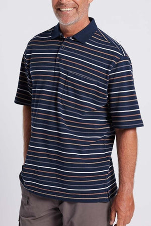 A man wearing the Breakaway Dariyan Cotton Pique Polo with a modern thin stripe design is standing against a plain background. The shirt features horizontal stripes in various shades of dark blue and white, and has a pocket on the left side of the chest. The man has a light complexion and short gray hair.