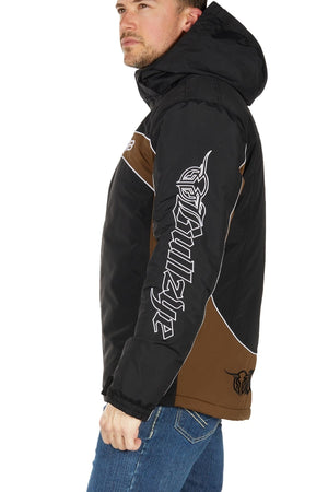 A man in profile wears the Bullzye Bazooka Jacket—rugged black and brown, waterproof, with white graphic text on the sleeve—against a plain white background.