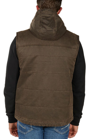 A person is seen from behind wearing the Bullzye Canon Vest, a brown hooded vest with visible stitching and a padded look, over a black long-sleeve shirt and blue jeans.