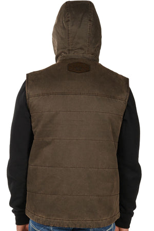 A person is seen from the back wearing the Bullzye Canon Vest—a brown quilted, hooded vest with a small patch near the shoulders—over a black long-sleeve shirt. The hood is up.