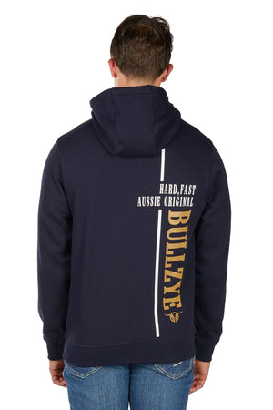 A person wearing the Bullzye Hardy Zip Up Hoodie in navy, hood up and seen from the back. The hoodie displays bold white and yellow text: "HARD, FAST AUSSIE ORIGINAL" and "BULLZYE." They are also wearing blue jeans.