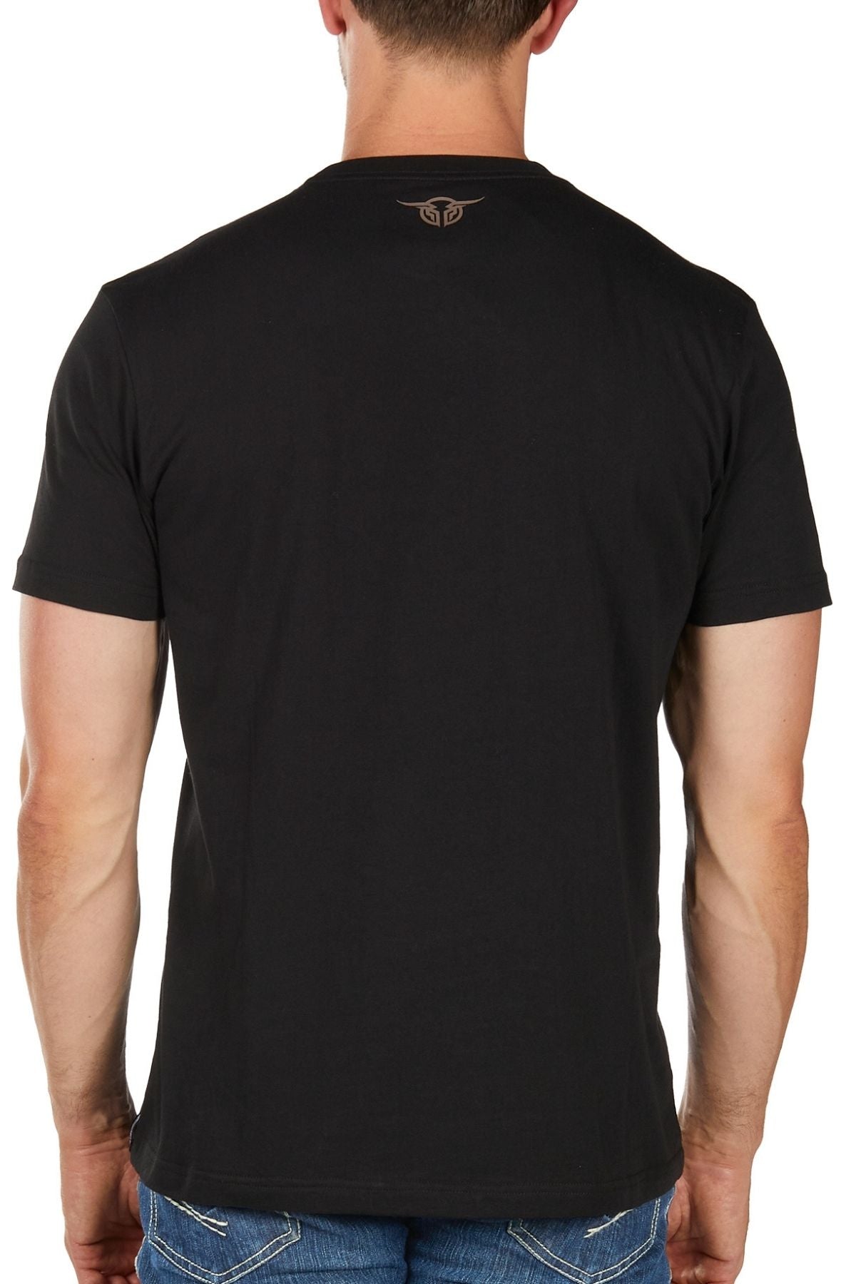 A man is shown from the back wearing the Bullzye Trademark Tee in plain black with blue jeans. The T-shirt, ideal for everyday wear, has a small logo below the neckline. The background is white.