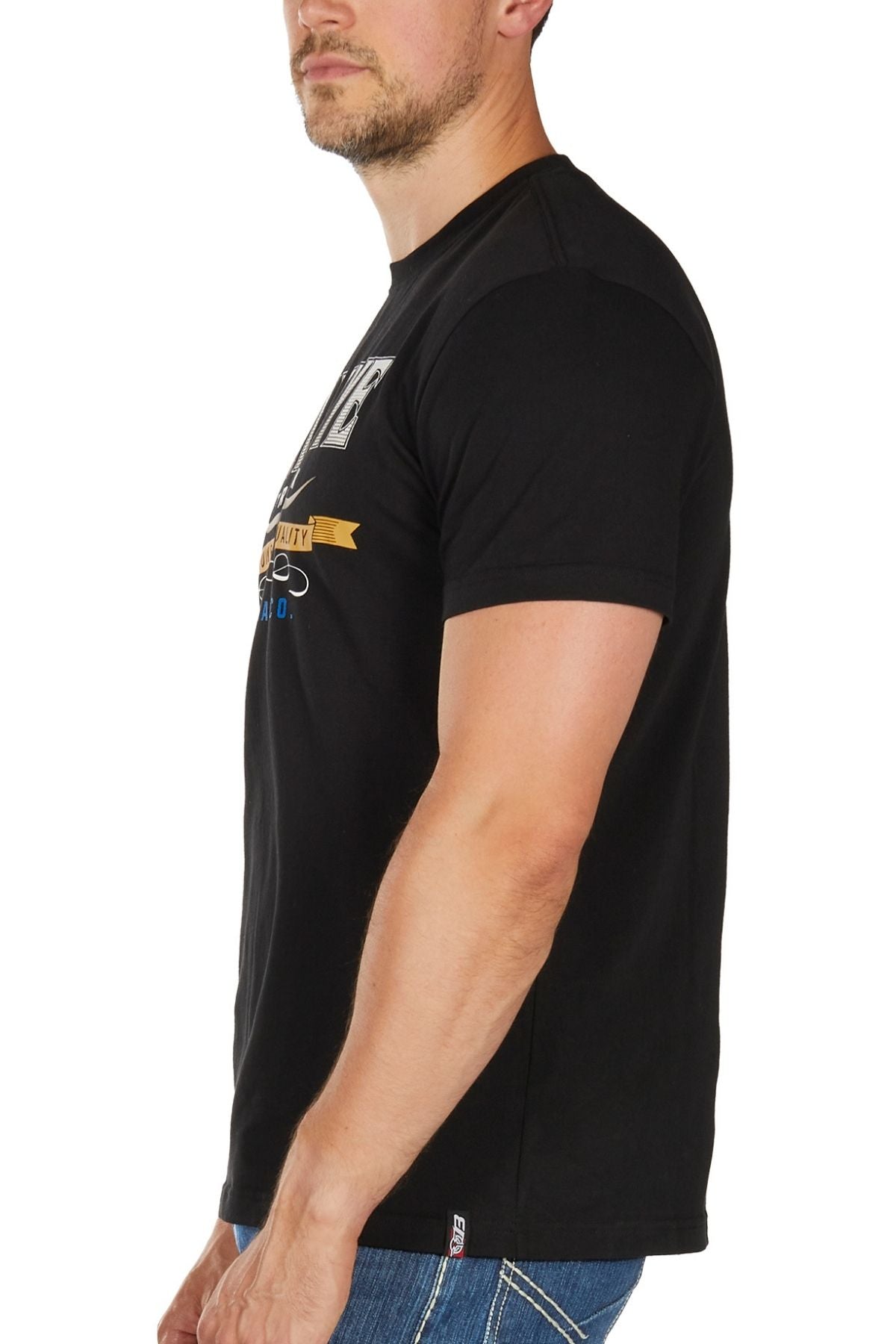 A man stands sideways facing left in a black Bullzye Trademark Tee and blue jeans against a plain white background, showcasing a classic look perfect for everyday wear.