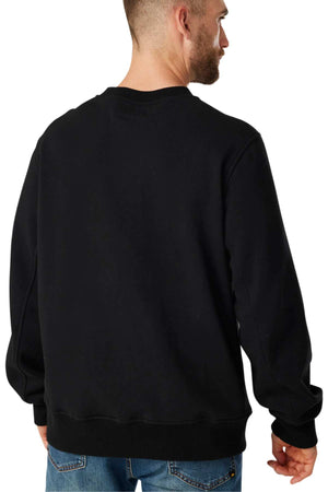 A man with short hair and a beard is facing away from the camera, wearing a black long-sleeve CAT Crewneck Sweatshirt crafted from durable fabric, paired with blue jeans.