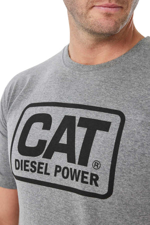 A person wears a CAT Diesel Power Tee with a black logo in a rectangular outline on the front, complemented by a rib collar. The bold design stands out while partially obscuring the wearer.