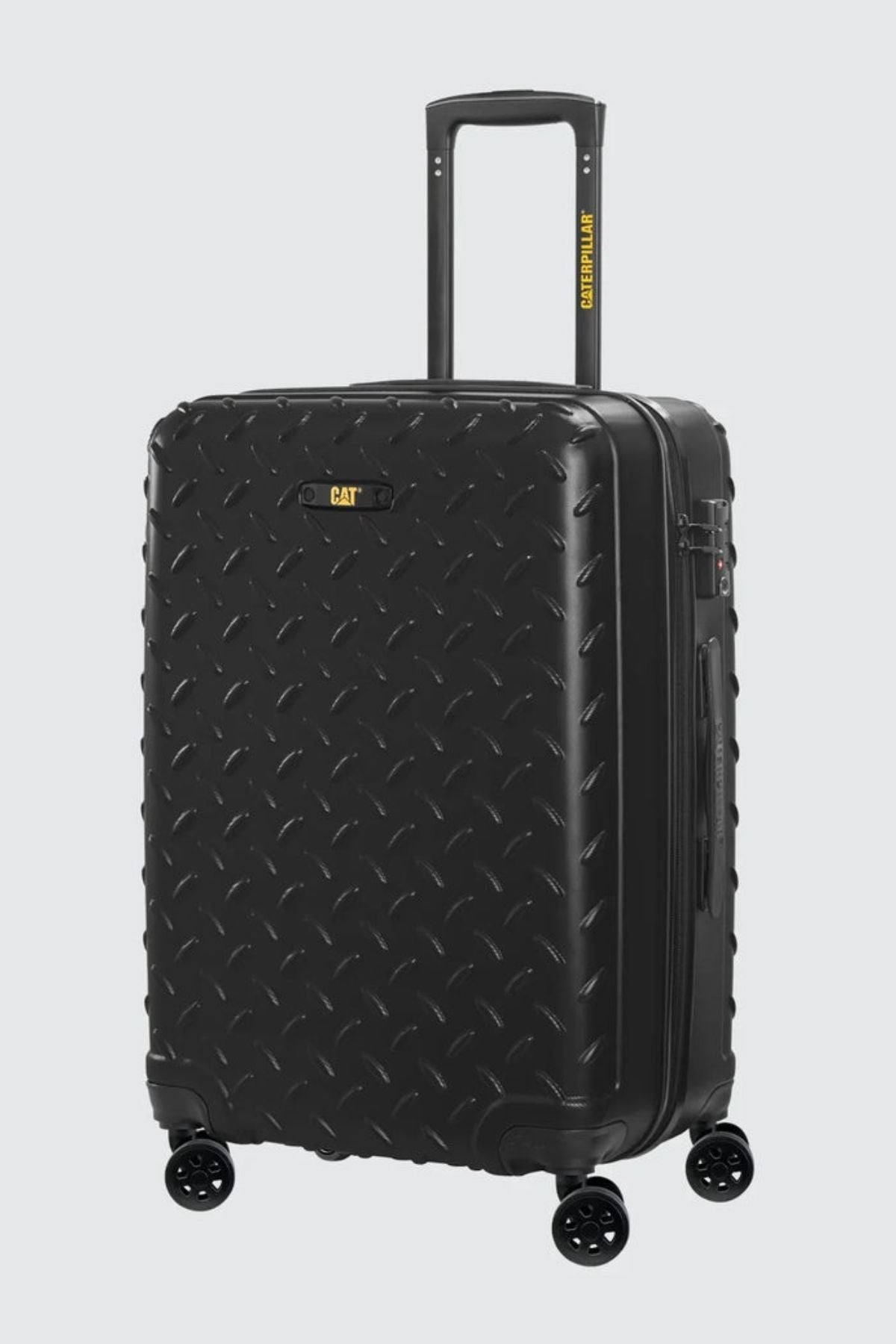 The CAT Industrial Plate 28" Trolley is a black hard-shell check-in luggage with a diamond plate texture, four wheels, a telescopic handle, and a yellow CAT logo near the top.