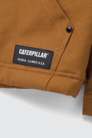 Close-up of a brown CAT Hooded Sherpa Lined Jacket with a black label reading "Caterpillar, Peoria, Illinois U.S.A.," visible stitching, and a black metal snap button.