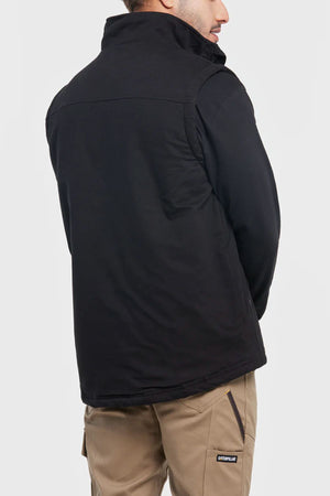 A person is shown from the back wearing a black CAT Sherpa Lined Vest and tan pants featuring a Caterpillar logo on the pocket, standing against a plain light background.