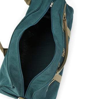 The RM Williams Nanga Canvas Bag, made from durable cotton canvas, features beige straps and an open main zipper compartment revealing a spacious duffle-style interior.