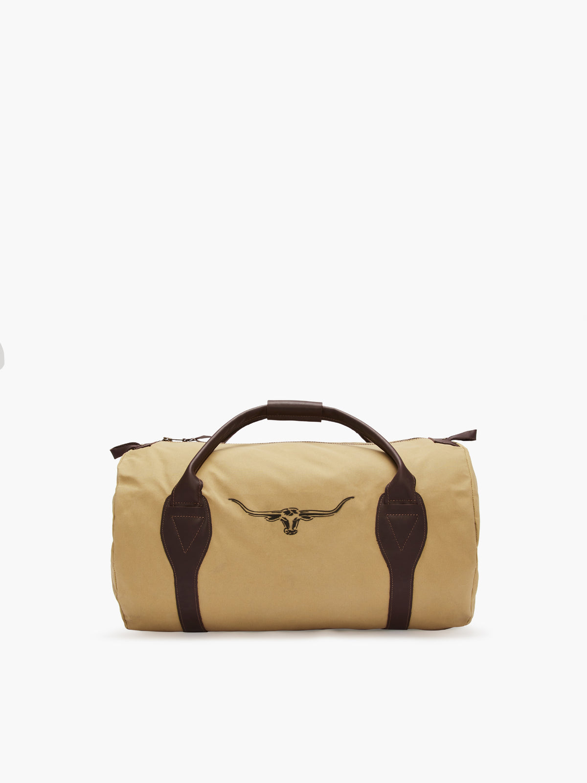 The RM Williams Canvas Ute Bag is a beige cylindrical bag made from water-resistant canvas, featuring dark brown leather handles and accents. It sports an embroidered longhorn skull logo on the front, combining simplicity and ruggedness—ideal for travel or gym use.