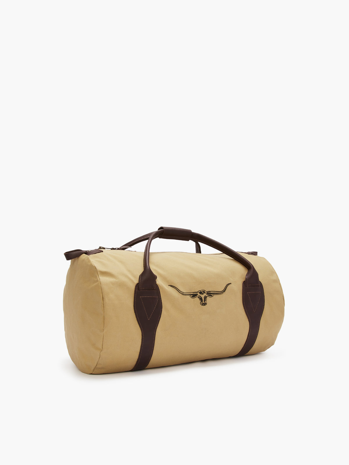 The RM Williams Canvas Ute Bag is made of water-resistant canvas with a tan finish, dark brown leather handles and accents, and features a distinctive longhorn emblem on its side against a white background.
