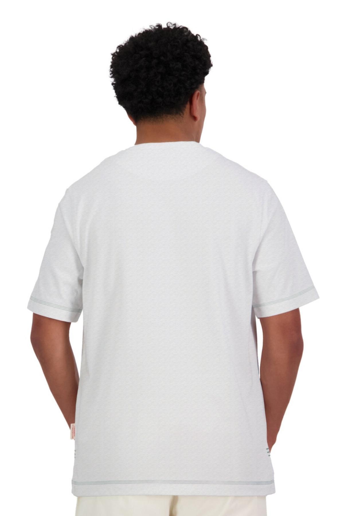 A person with short, curly hair is seen from behind wearing an oversized Canterbury CCC Collection T-Shirt in plain white and matching pants, posed against a white background.
