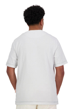 A person with short, curly hair is seen from behind wearing an oversized Canterbury CCC Collection T-Shirt in plain white and matching pants, posed against a white background.