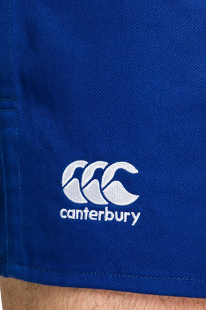 Here's a rewritten version of the sentence using the given product data:
A close-up of the Canterbury Rugged Drill Short in blue fabric highlights its elasticated waist and tape side pockets. The distinctive Canterbury logo, featuring three overlapping white curves with "canterbury" embroidered below, enhances its unique style.