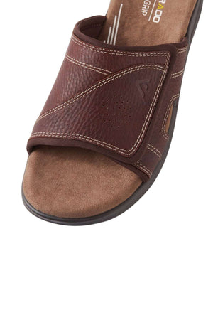 Close-up of the Colorado Iver Leather Slides: brown leather with decorative stitching, textured footbed, slip-resistant sole for stability. Features subtle branding and an easy slip-on design.