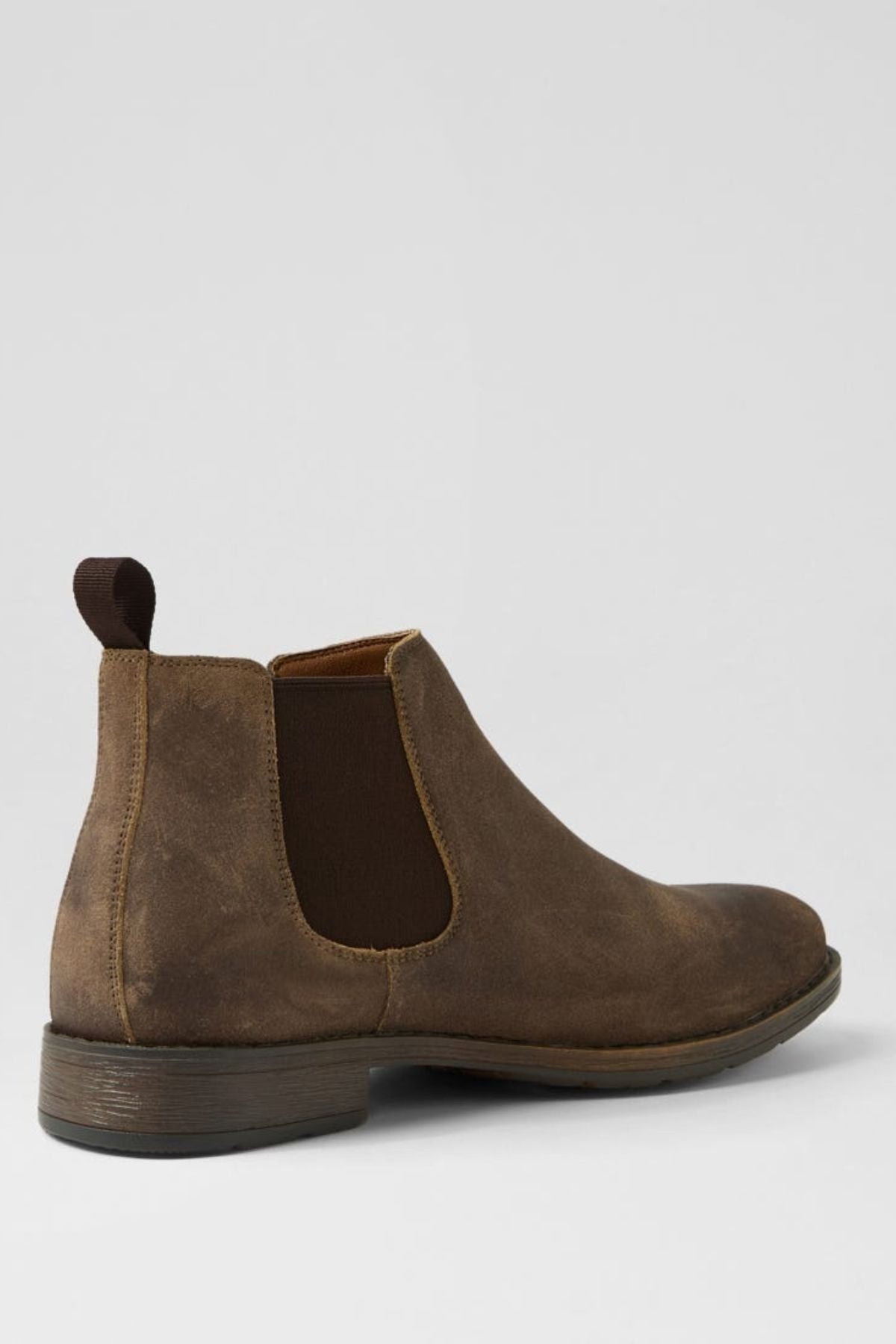 The Colorado Lizard Oil Suede Boot, a single brown Chelsea boot with elastic side panels, pull tab, and durable sole, is displayed against a plain light gray background.