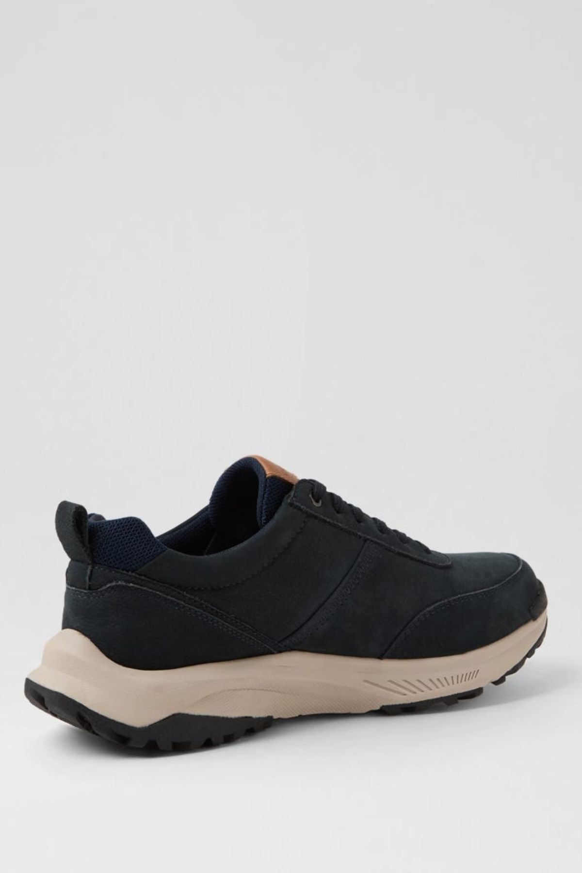 The Colorado Suzuki Shoe is a black sneaker made from premium leather, featuring a beige slip-resistant sole with black tread, shown from the back side angle against a plain light gray background.