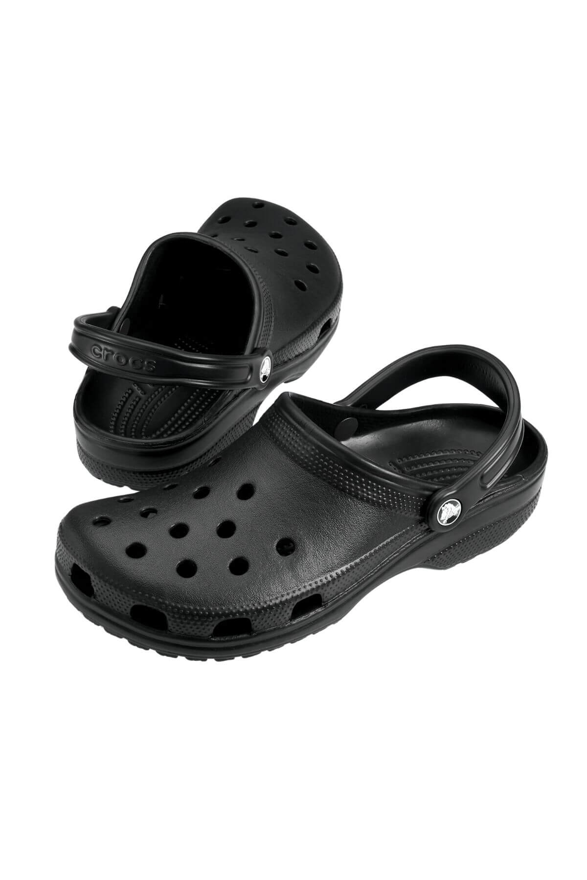 A pair of black Crocs Classic Clog with back straps and ventilation holes, ideal for a lightweight water adventure, is displayed on a white background. The left clog is slightly in front and angled to the side, while the right clog faces forward.