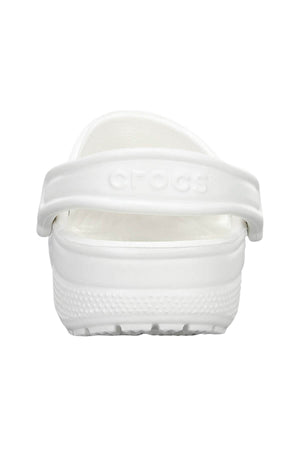 Back view of a single Crocs Classic Clog in white, showcased with an embossed "Crocs" logo on its heel strap and a textured outsole. Lightweight and breathable, it's your ideal companion for a water adventure.