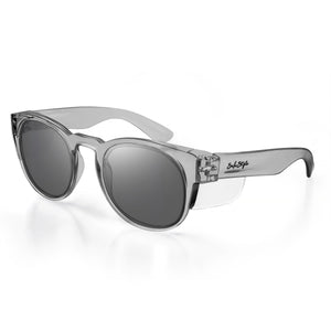 Shown against a plain white background, the SafeStyle Cruisers Graphite Frame Tinted Lens sunglasses feature clear frames with dark lenses. They offer UV400 protection and exhibit sleek, wide arms adorned with the brand's signature logo in black, ensuring both style and safety.