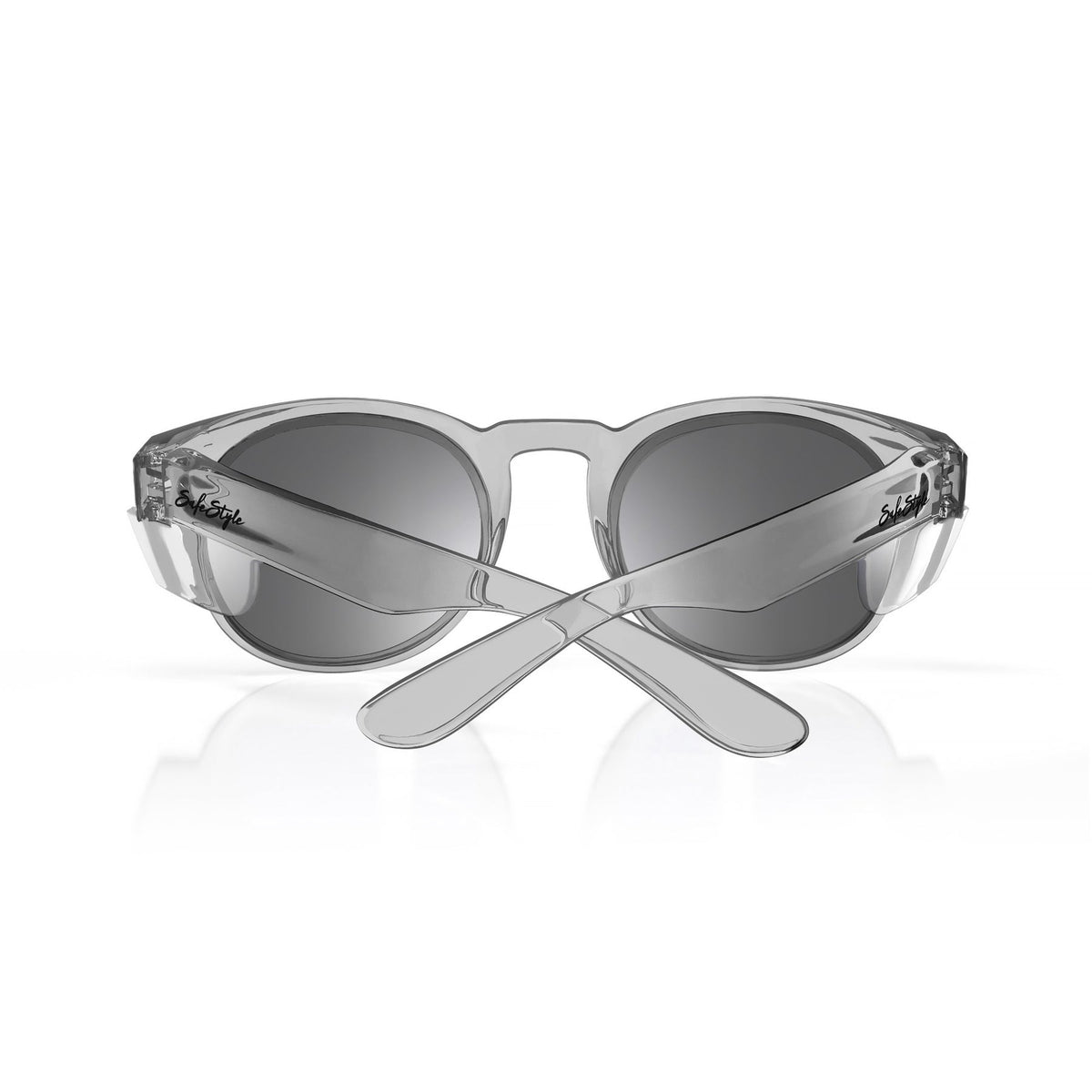 A pair of stylish, grey SafeStyle Cruisers Graphite Frame Tinted Lens sunglasses with dark lenses is shown, with the arms crossed in an X shape. The brand logo is engraved on the sides of the arms, and the glasses, boasting UV400 protection and safety ratings, are positioned against a plain white background.