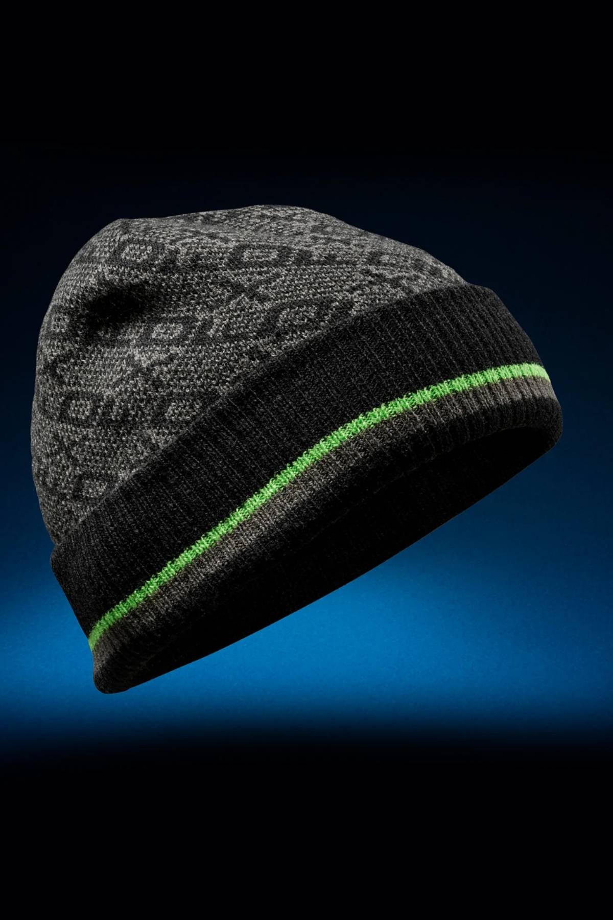 The FXD CP-11 Jacquard Beanie is a gray winter accessory made from 100% acrylic, featuring a subtle pattern, black cuff, and bright green stripe, shown against a blue gradient background.