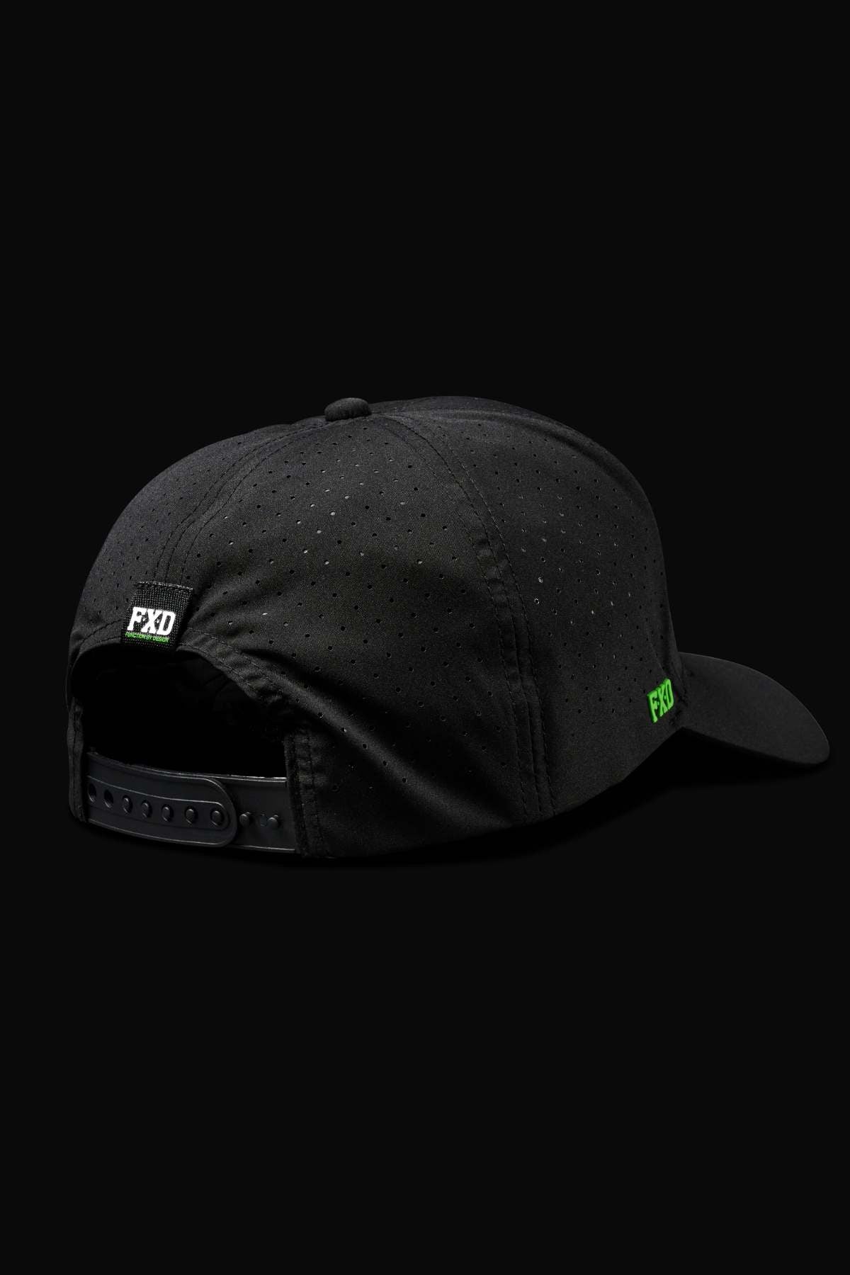 The FXD CP-12 Tech Baseball Cap, shown from the back, is black with an adjustable snap-back strap, small ventilation holes, quick-dry fabric, and green "FXD" logos on the strap and side.