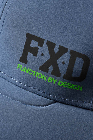 A close-up of the FXD CP-12 Tech Baseball Cap's gray fabric reveals bold black "FXD" letters and green "FUNCTION BY DESIGN" text. Made of quick-drying polyester with visible stitching, it enhances breathability for active wear.