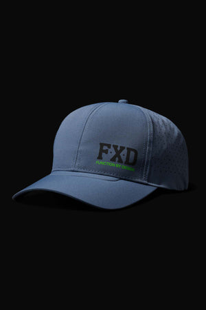 The FXD CP-12 Tech Baseball Cap is blue with "FXD" in bold black lettering and "FUNCTION BY DESIGN" in green. Made from quick-drying performance polyester, it features ventilated side panels for breathability. Shown on a black background.