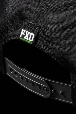 Close-up of the back of the FXD CP-13 Trucker Cap, showcasing a black, adjustable snap-back strap. Above the strap, a label with "FXD" and "Function by Design" is visible. The cap's breathable material gives it a textured appearance.