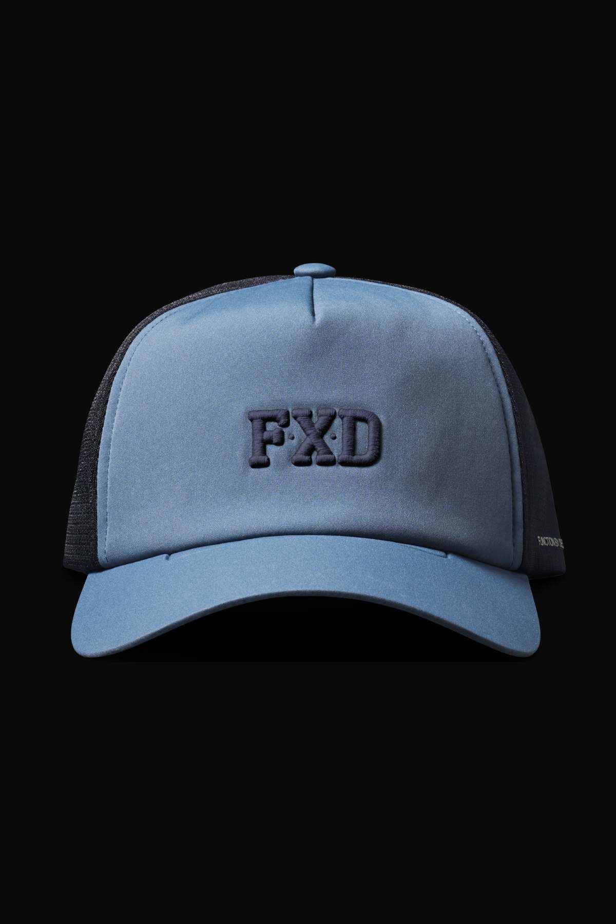 The FXD CP-13 Trucker Cap in blue and black features embroidered "FXD" on the front. Made from breathable fabric, it includes a moisture-wicking sweatband for comfort and is set against a dark backdrop.