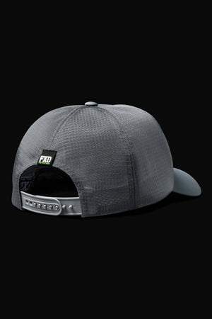 The FXD CP-13 Trucker Cap is displayed from the back, showing its gray mesh, breathable material, adjustable snap-back closure, and a small black patch with "FXD" lettering. The cap is set against a solid black background.