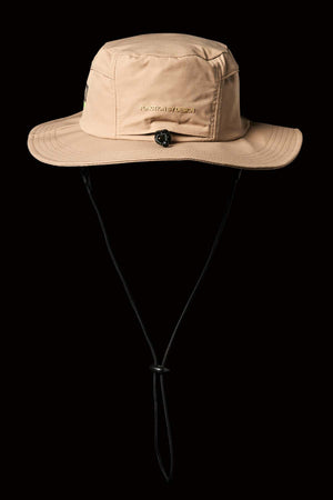The FXD CP-14 Boonie Hat is beige with a wide brim, an adjustable black chin strap, and a small emblem on the front. It offers quick-drying sun protection against a black background, perfect for any adventure.